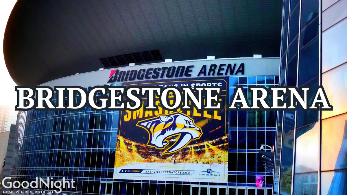 The exterior of Bridgestone Arena, featuring the distinctive sign and Predators logo, with banners advertising events. The setting is alive with the anticipation of sports games, concerts, and large-scale public gatherings.