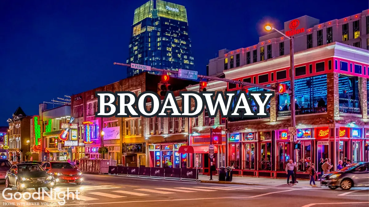 This bustling nighttime city scene features neon signs, crowded streets, and modern skyscrapers. The vibrant ambiance suggests a lively nightlife with people dining, enjoying live music, and exploring the energy of downtown Nashville.