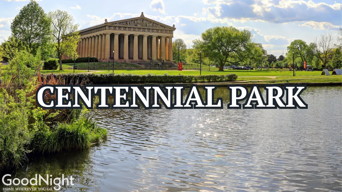 This image captures the iconic Parthenon-like structure set amidst the lush greenery and serene lake of Centennial Park. The tranquil atmosphere, with people strolling and enjoying the park, highlights the beauty and accessibility of the landmark just steps from the property.